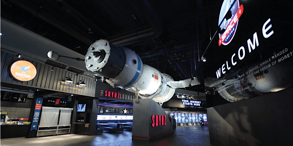Photo of interior of National Space Center with display of Soyuz spacecraft.