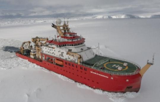 Photo of a big red ship icebreaking